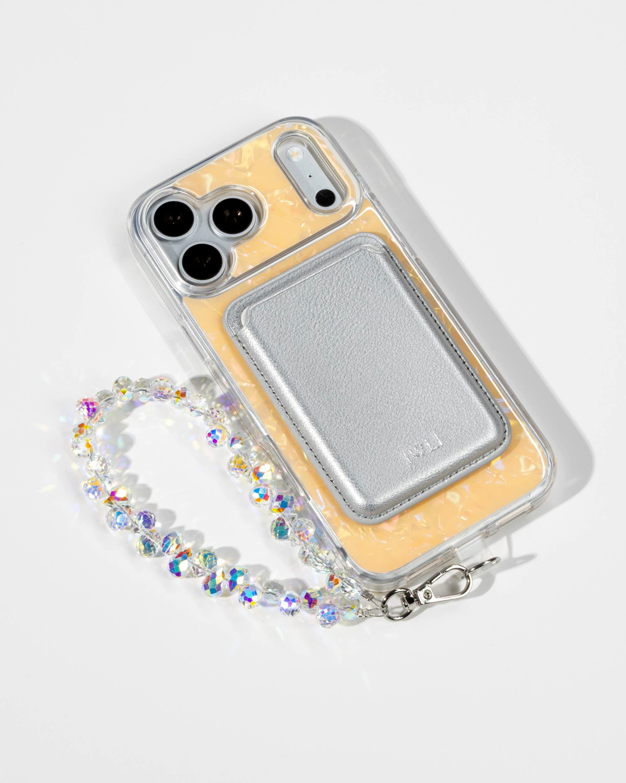 Apricot Shell iPhone Case with a Silver Muse MagSafe Wallet attached
