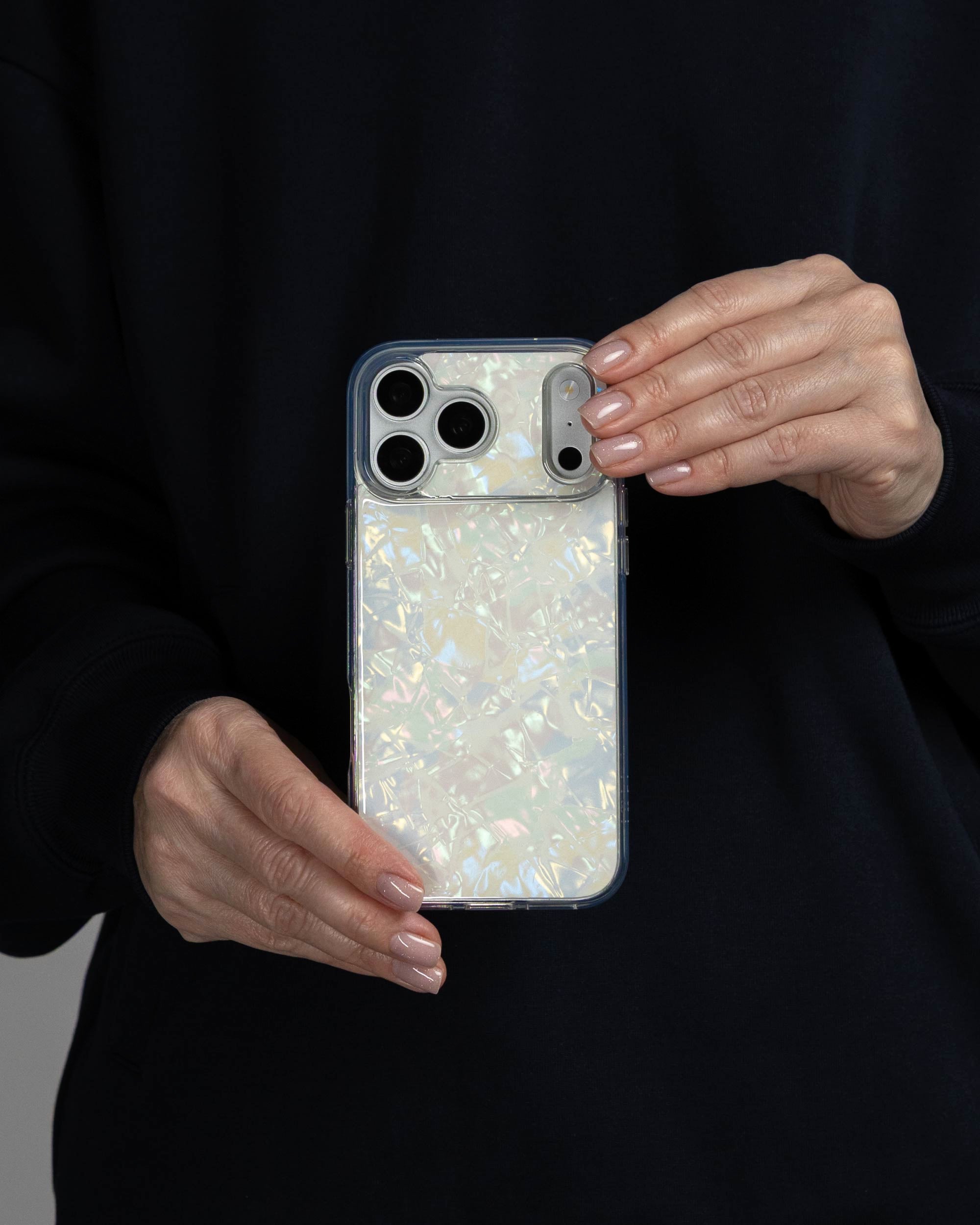 White Shell iPhone Case held in both hands, iPhone 17 Pro Max