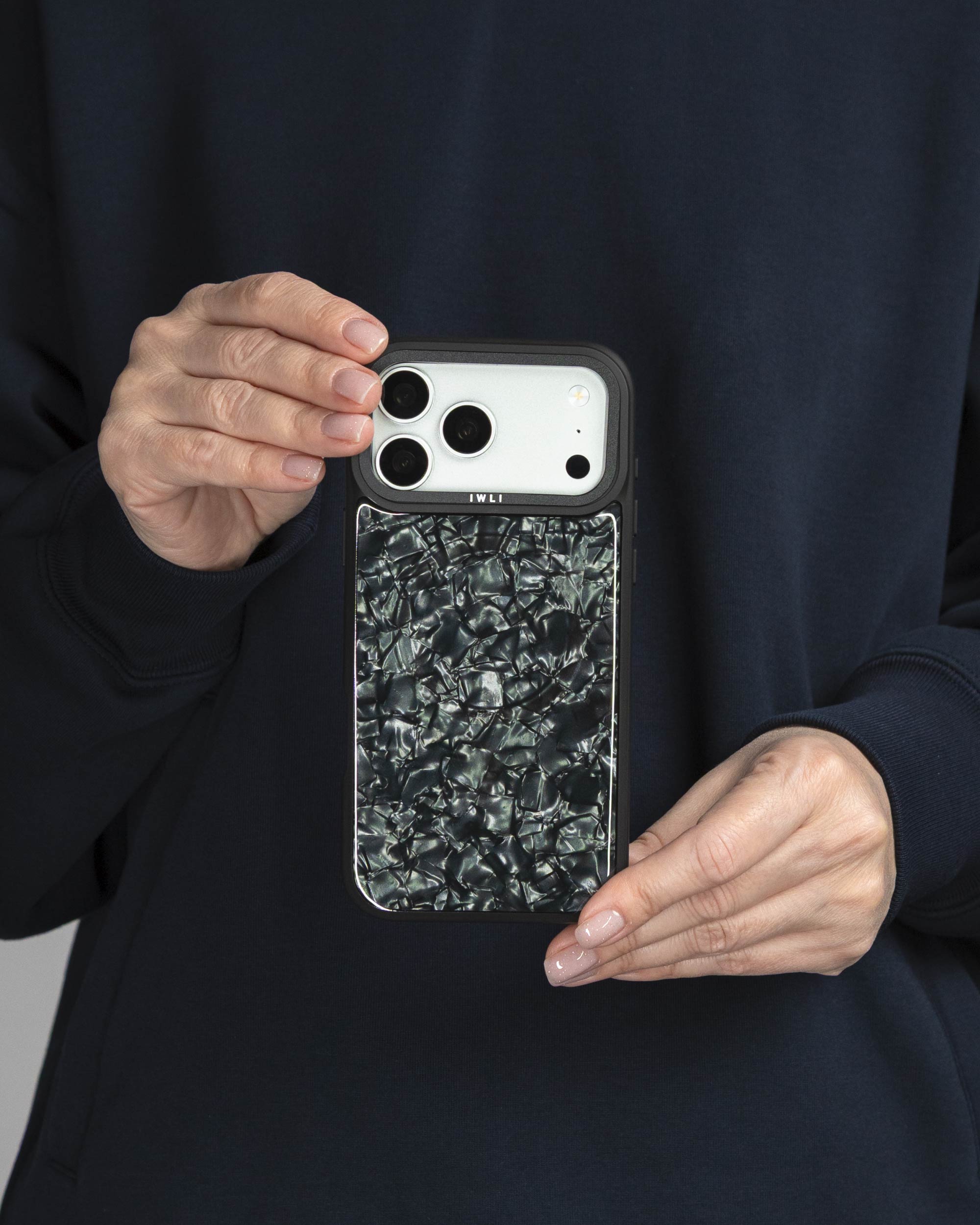 Black Shell iPhone Case held in both hands, iPhone 17 Pro Max