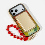 Sunset Fan Holo iPhone Case with a Gold Muse MagSafe Wallet attached