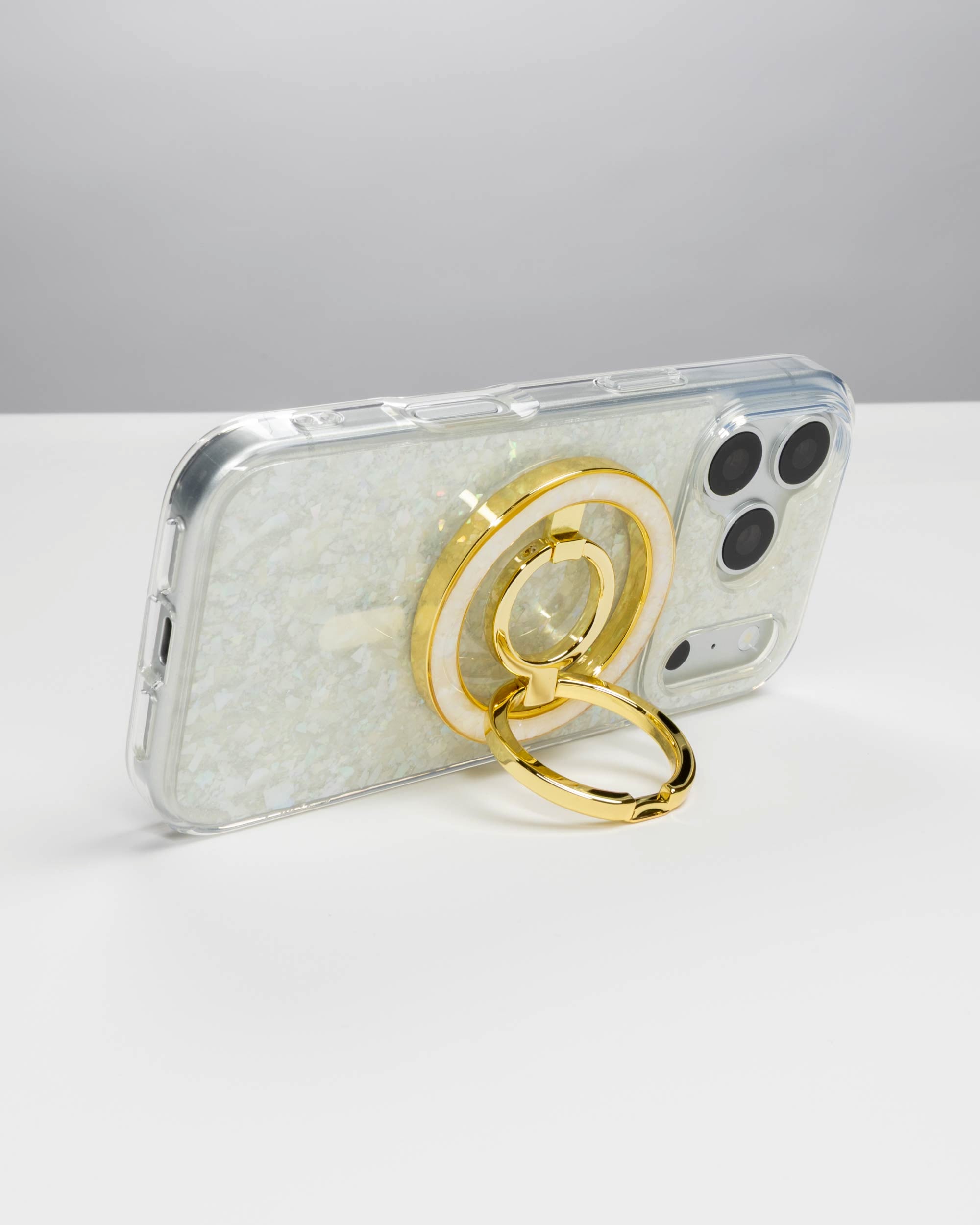 Snow Pearl Ring Stand, gold-tone, holding an iPhone in landscape as a stand