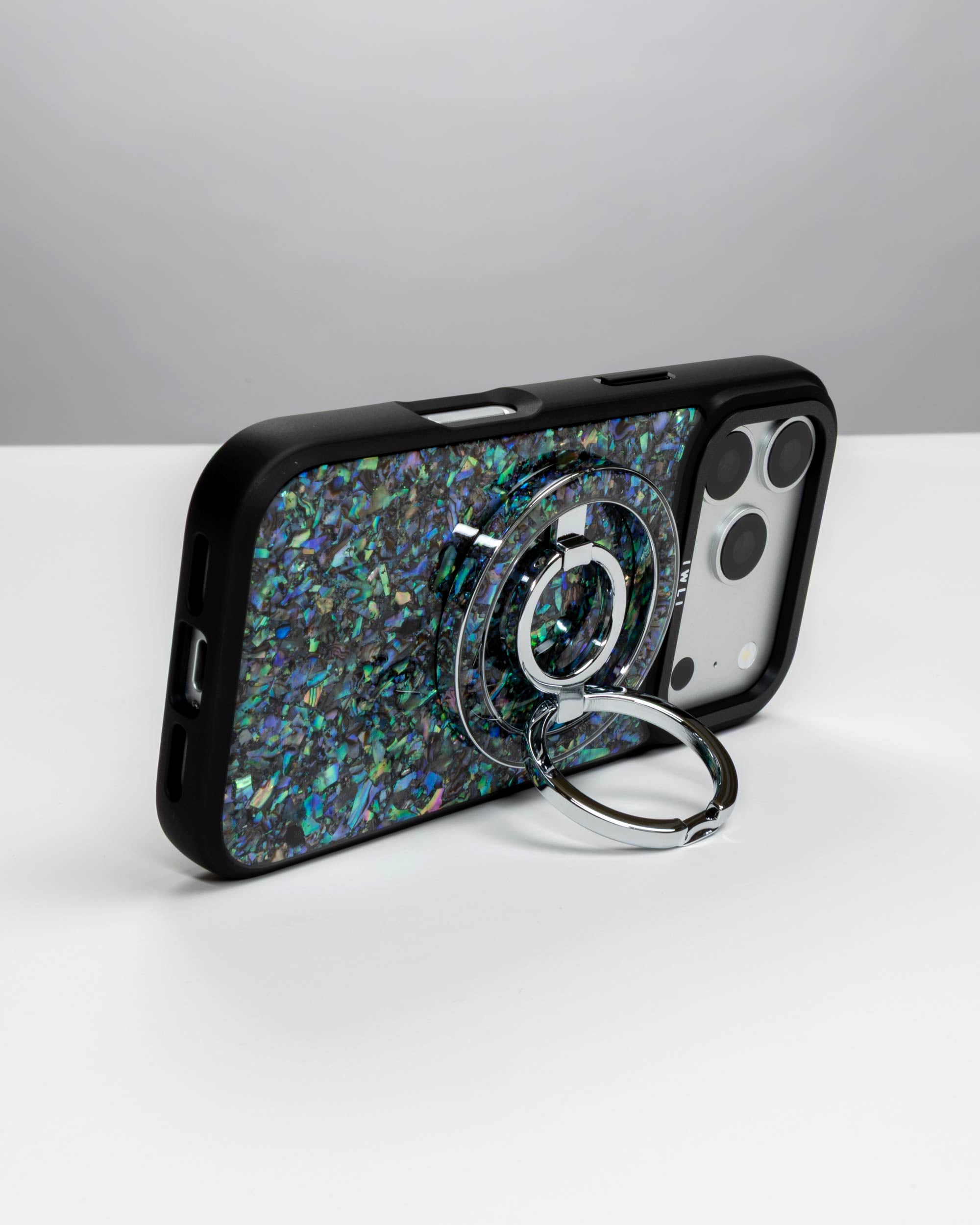 Abalone Pearl Ring Stand, silver-tone, holding an iPhone in landscape as a stand