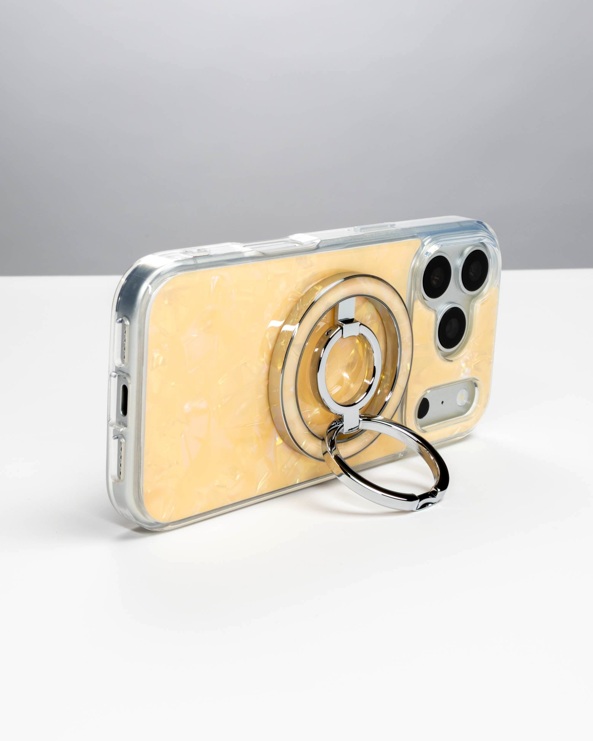 Apricot Shell Ring Stand, silver-tone, holding an iPhone in landscape as a stand