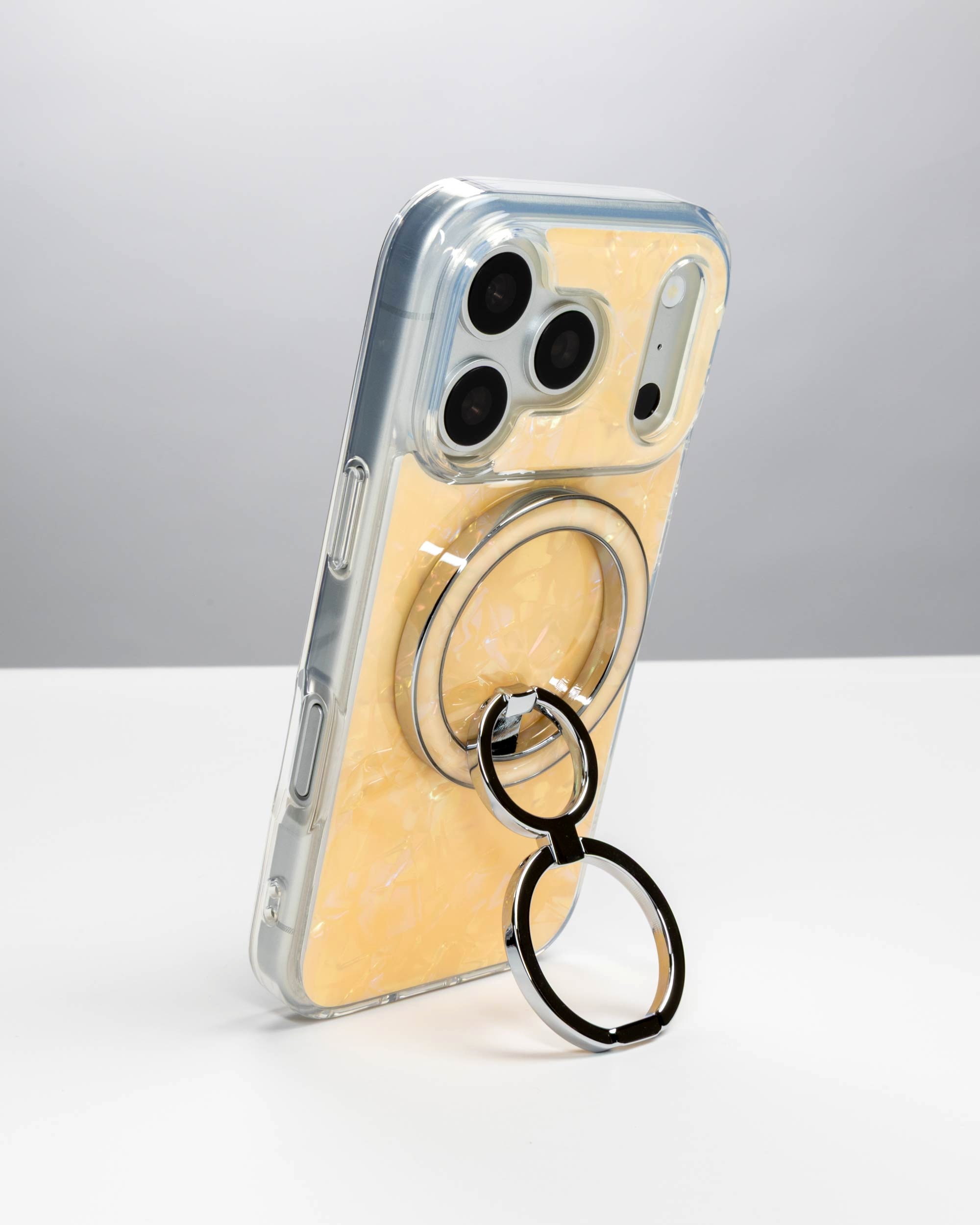 Apricot Shell Ring Stand, silver-tone, holding an iPhone upright as a stand