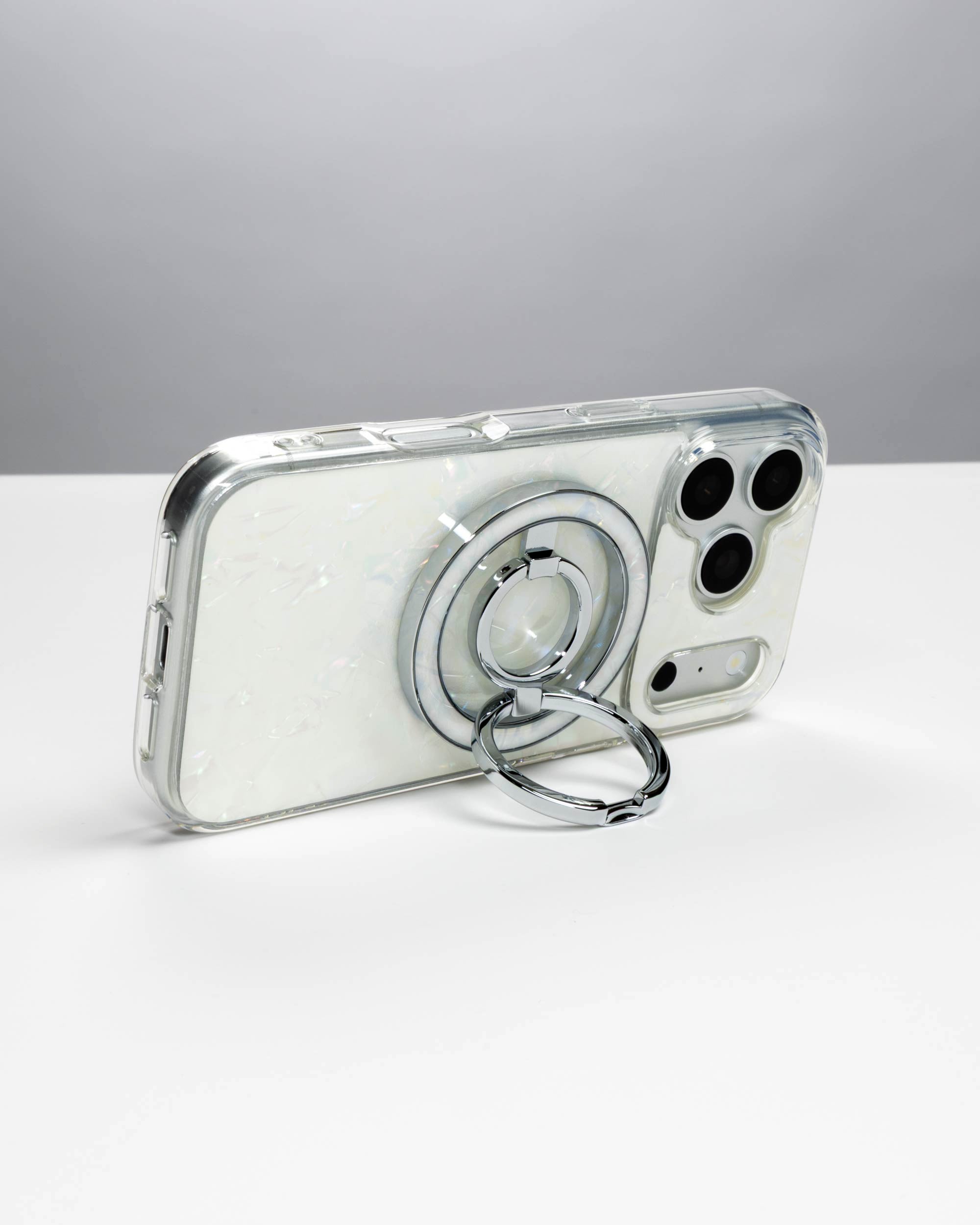 White Shell Ring Stand, silver-tone, holding an iPhone in landscape as a stand