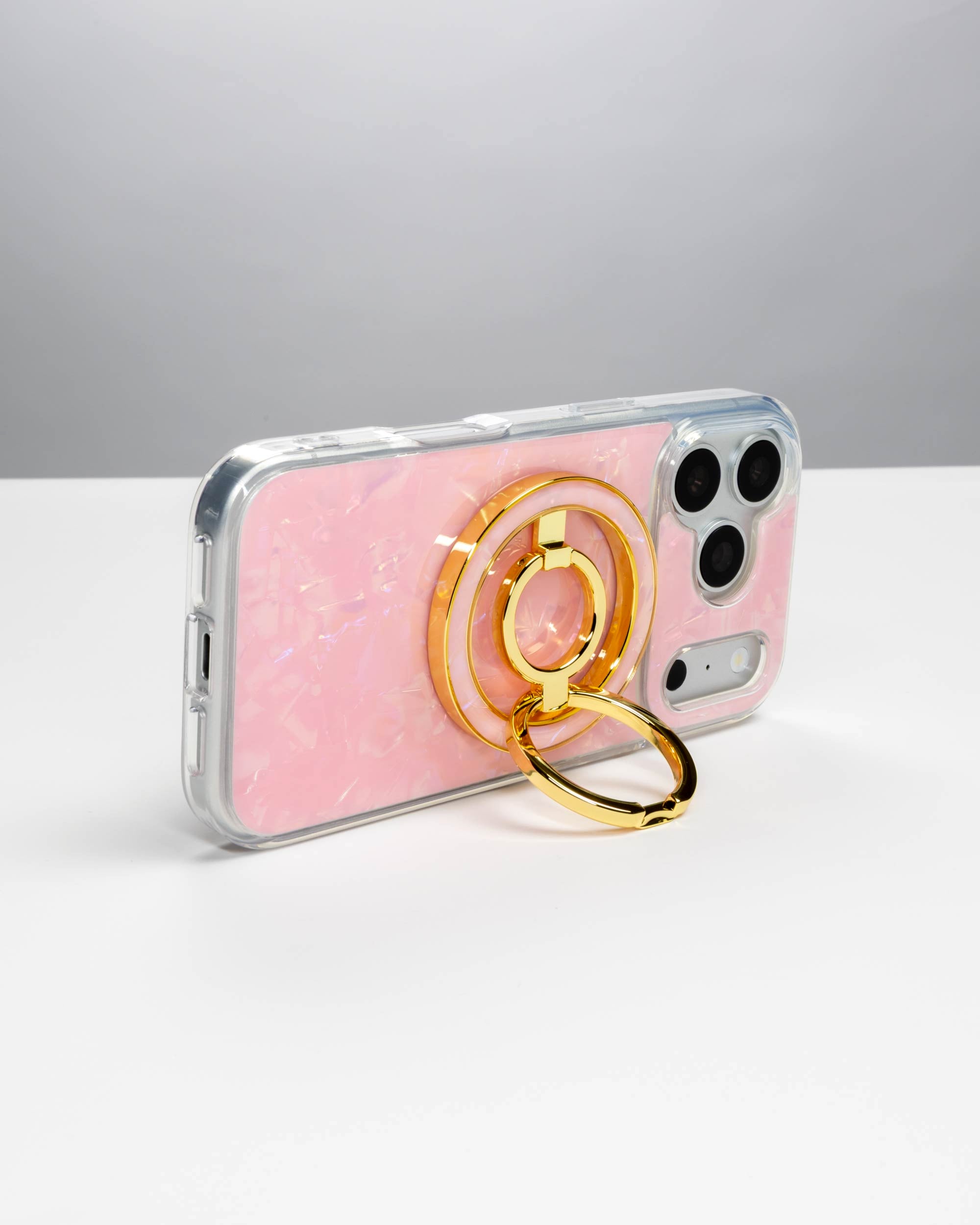 Pink Shell Ring Stand, gold-tone, holding an iPhone in landscape as a stand