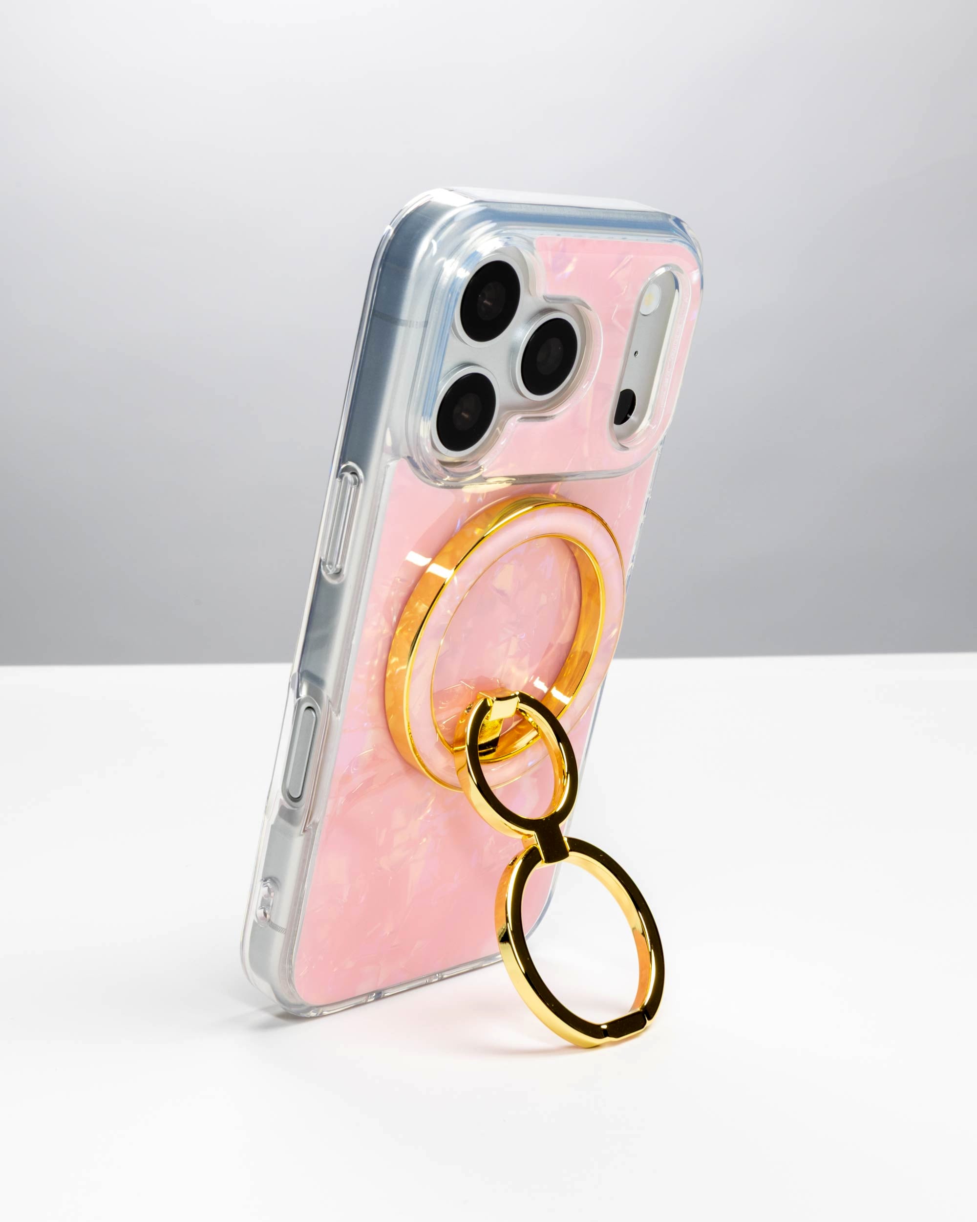 Pink Shell Ring Stand, gold-tone, holding an iPhone upright as a stand