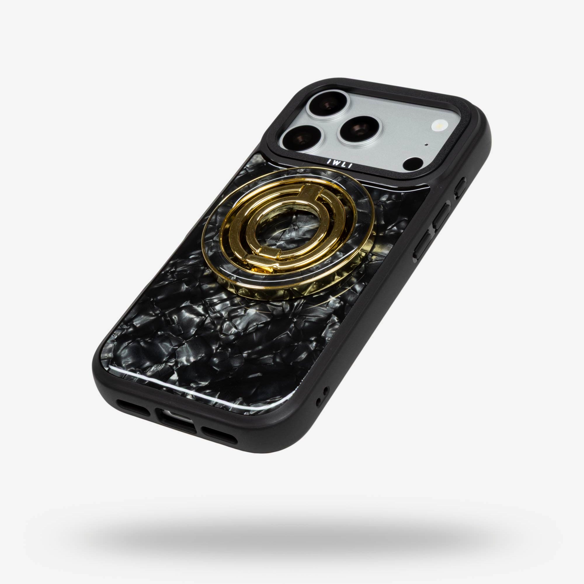Black Shell Ring Stand, gold-tone, folded flat on the back of an iPhone case