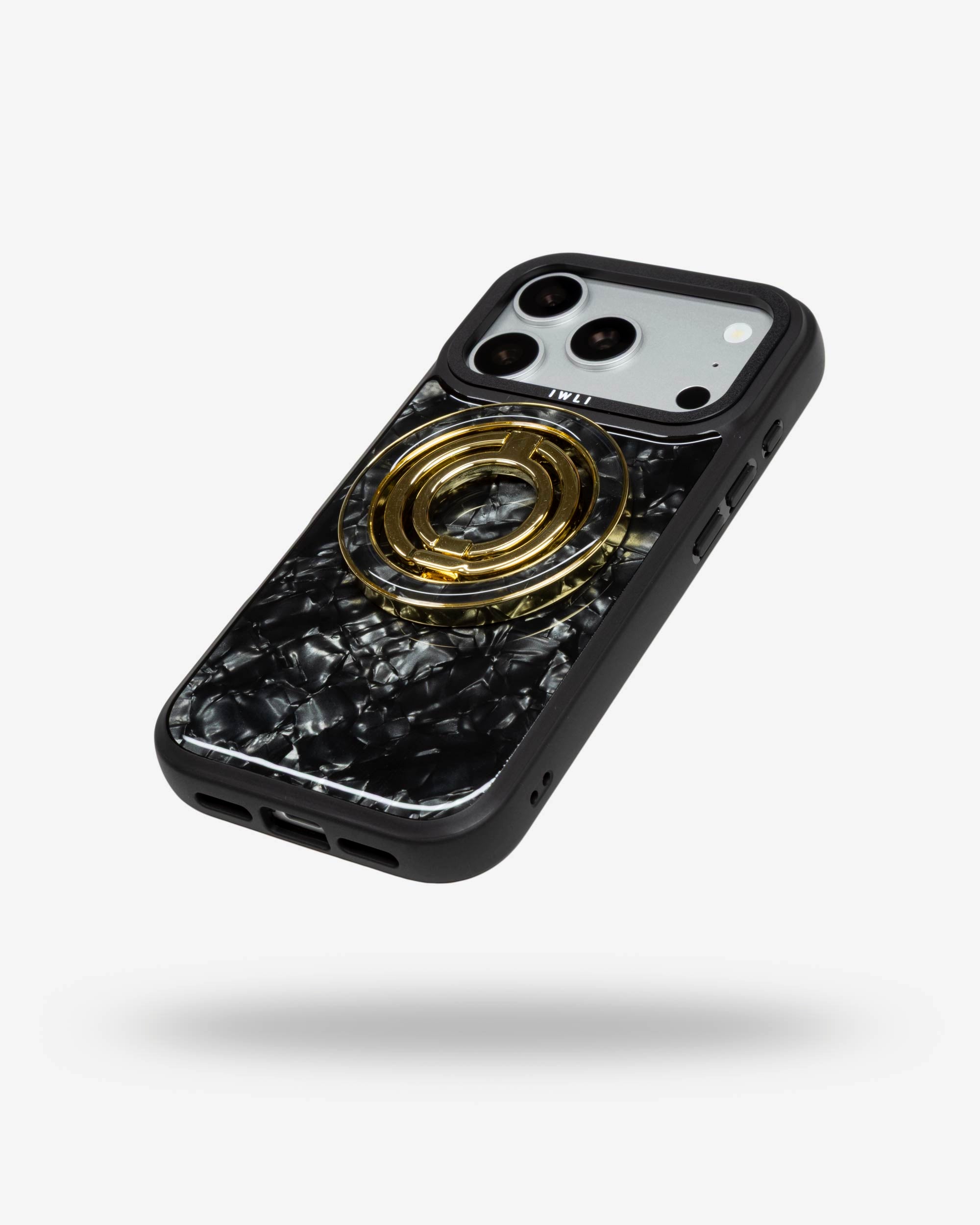 Black Shell Ring Stand, gold-tone, folded flat on the back of an iPhone case
