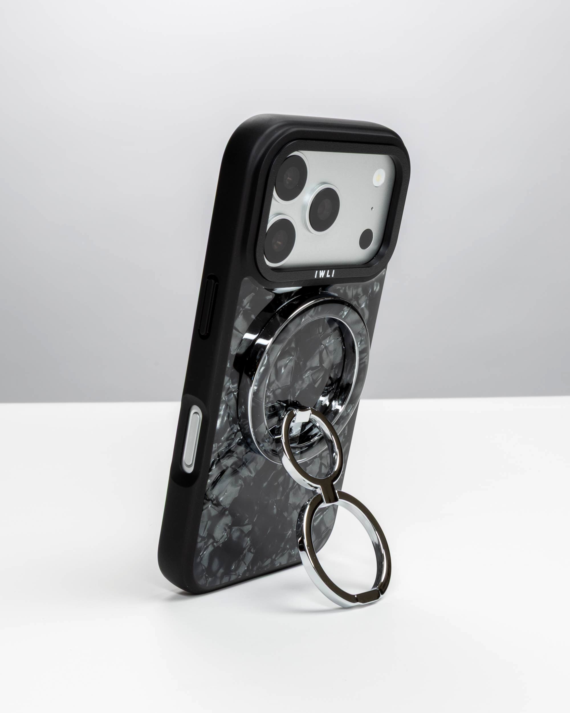 Black Shell Ring Stand, silver-tone, holding an iPhone upright as a stand
