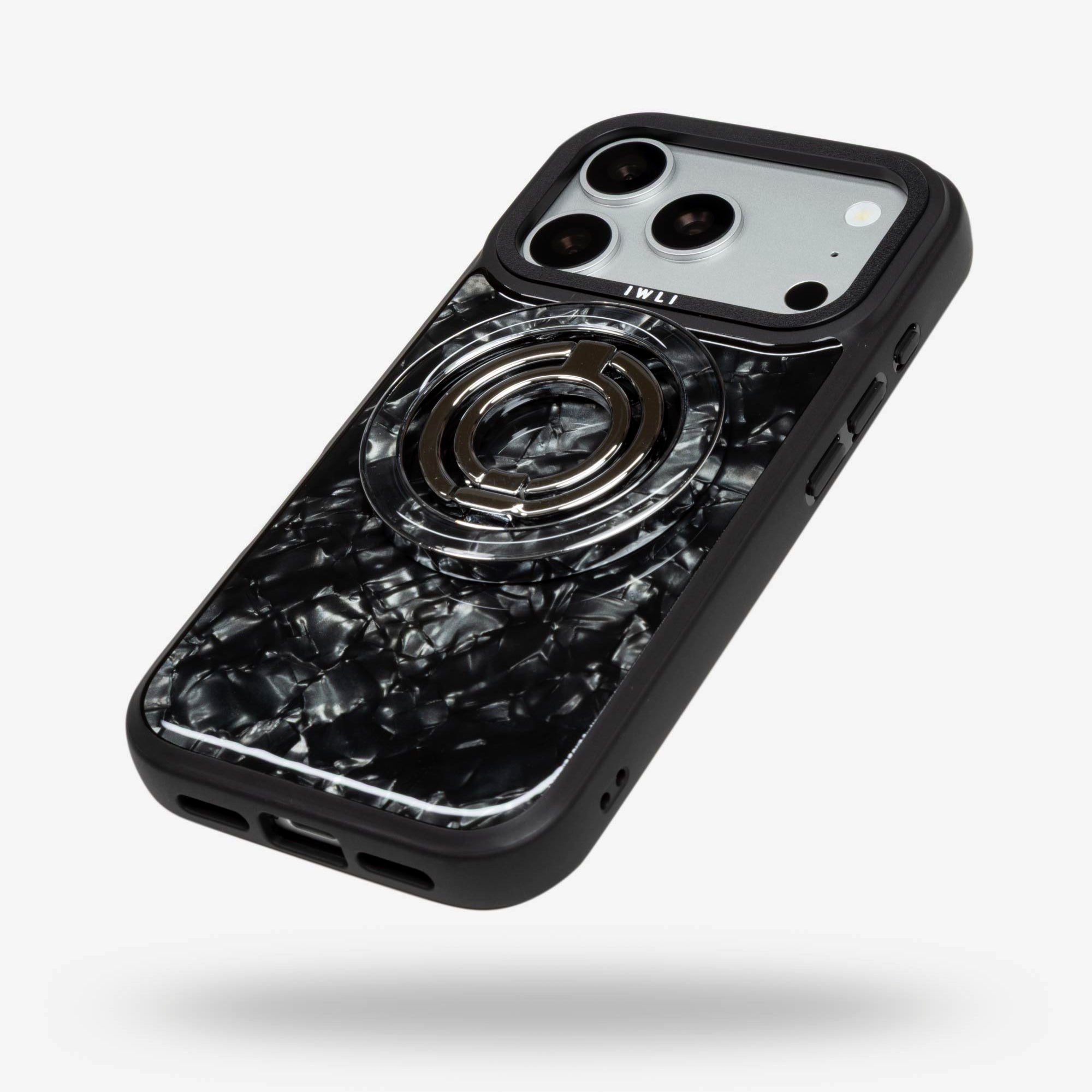 Black Shell Ring Stand, silver-tone, folded flat on the back of an iPhone case