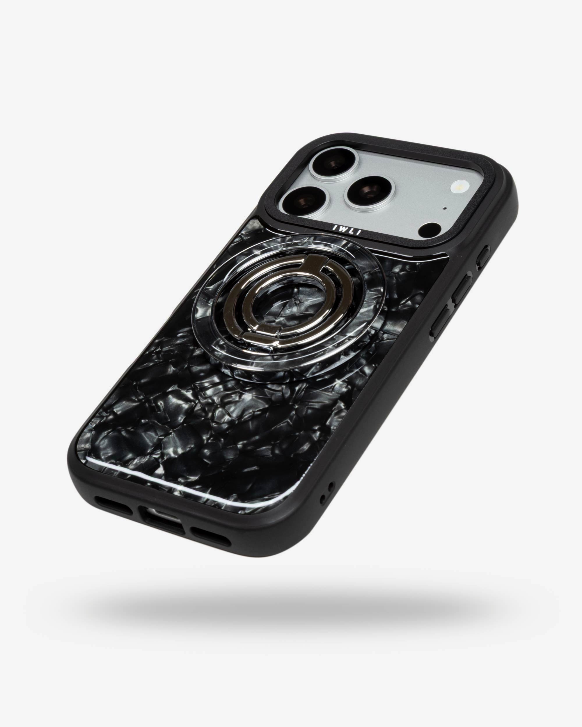 Black Shell Ring Stand, silver-tone, folded flat on the back of an iPhone case