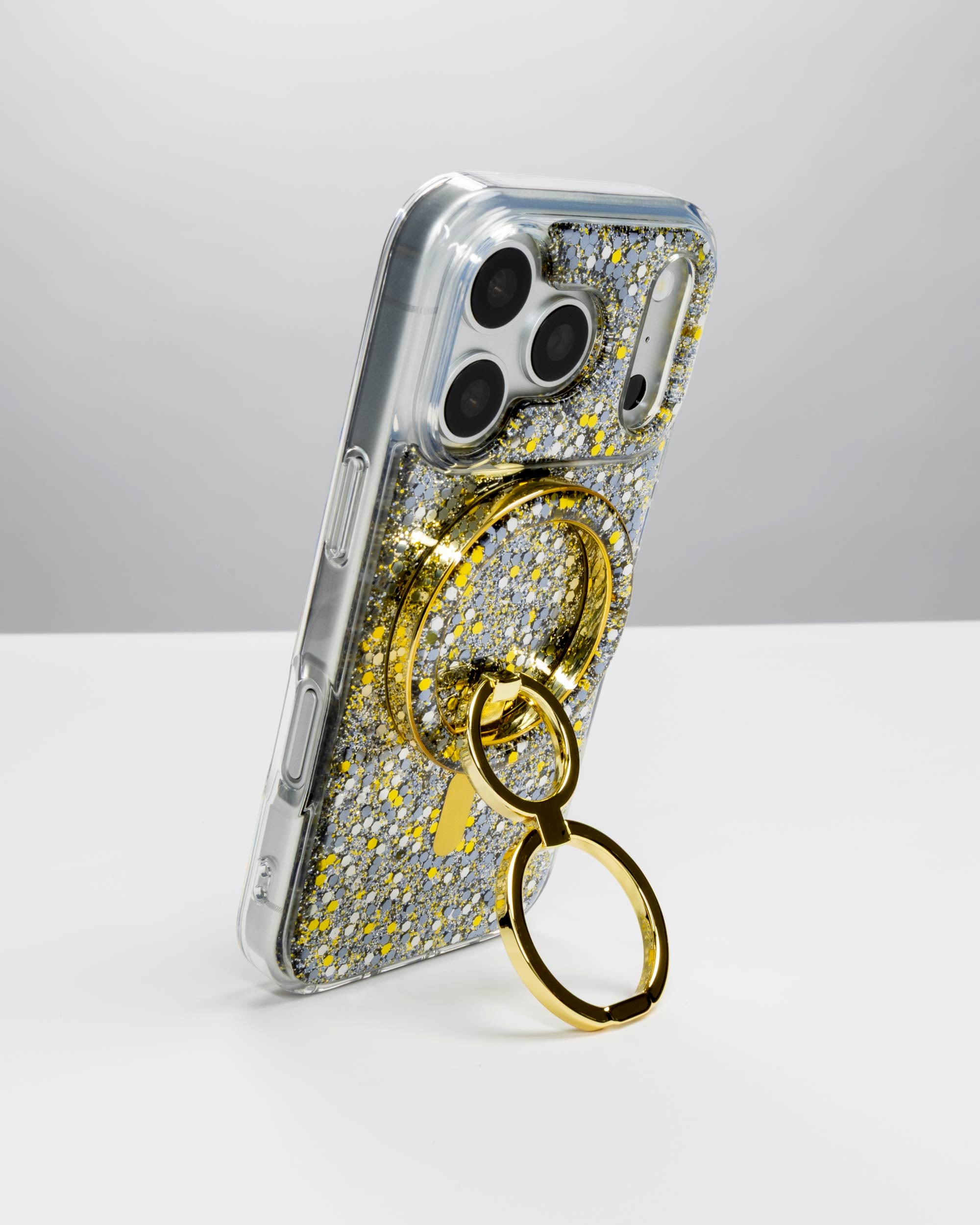 Starlight Sparkle Ring Stand, gold-tone, holding an iPhone upright as a stand