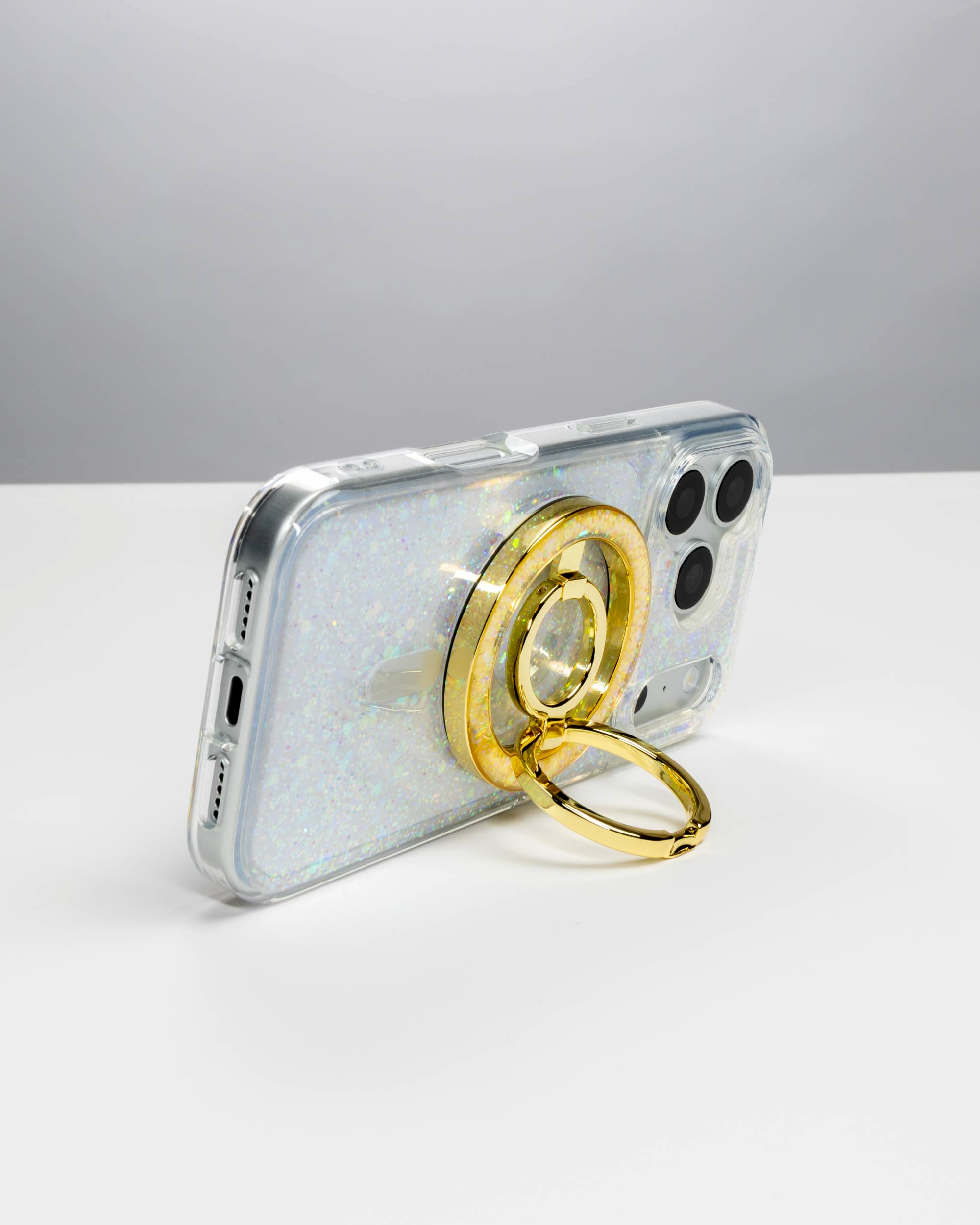 Opal Sparkle Ring Stand, gold-tone, holding an iPhone in landscape as a stand